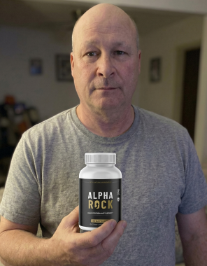 An Alpha Rock customer holding a bottle of the male performance support capsules