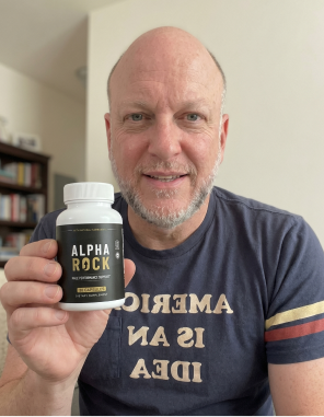 An Alpha Rock customer holding a bottle of the male performance support capsules